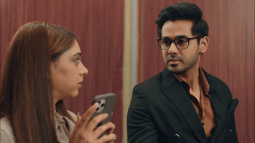 Man And Woman Looking At Phone GIF