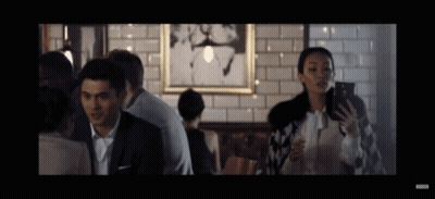 Man And Woman Looking At Phones In Restaurant GIF