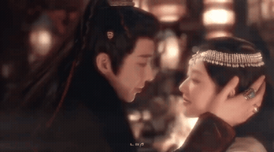 Man And Woman Looking Into Each Other's Eyes In Dark Room GIF