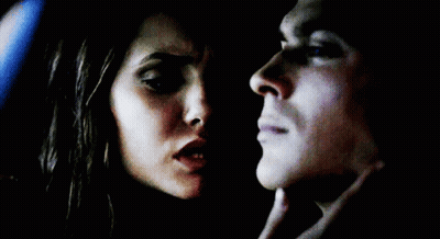 Man And Woman Looking Into Each Other's Eyes In Dark Room GIF