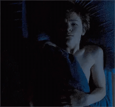 Man And Woman Lying On Bed Holding Hands GIF