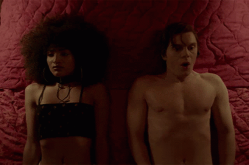 Man And Woman Lying On Bed With Red Blanket GIF