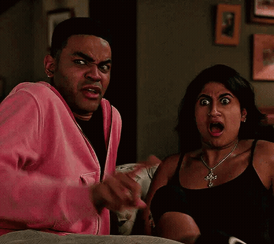 Man And Woman Making Funny Faces On Couch GIF