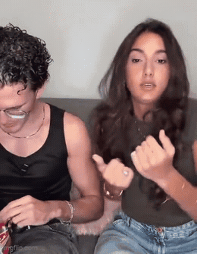 Man and Woman Making Funny Faces on Couch