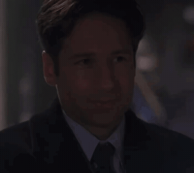 Man And Woman Making Funny Faces On Couch GIF