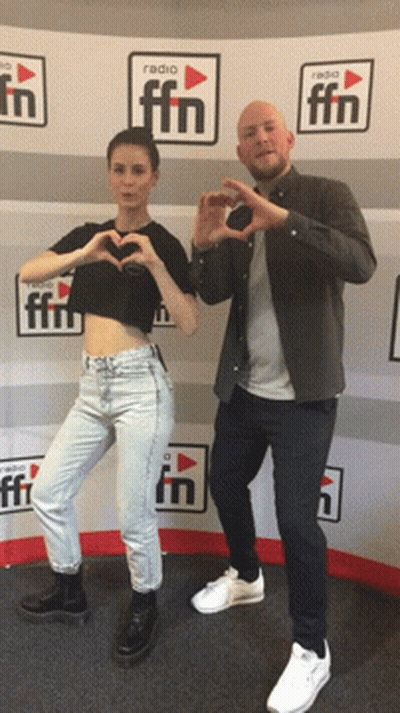Man And Woman Making Hearts In Front Of Radio FM Wall GIF