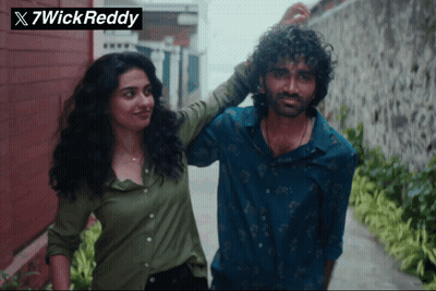Man And Woman Next To 7Wick Reddy Logo GIF