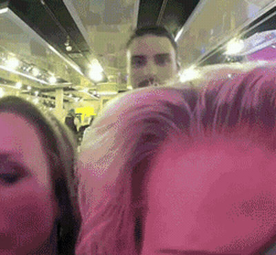 Man And Woman Next To Each Other In Pink Room GIF