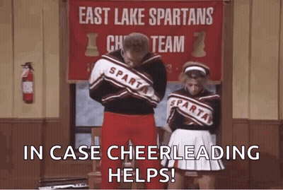 Man And Woman Next To East Lake Spartans Cheer Sign GIF