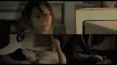 Man And Woman On Bed Woman On Phone GIF