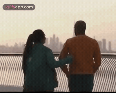 Man And Woman On Bridge Overlooking City GIF