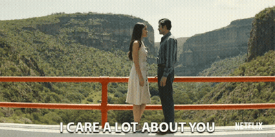 Man And Woman On Bridge Saying I Care A Lot About You GIF