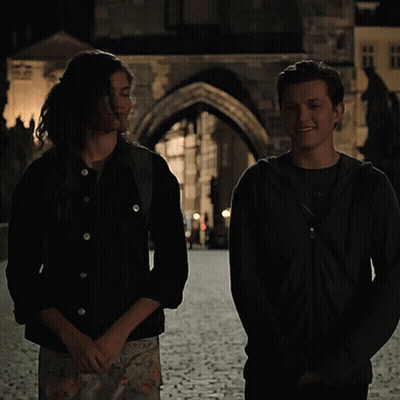 Man And Woman On Cobblestone Street GIF