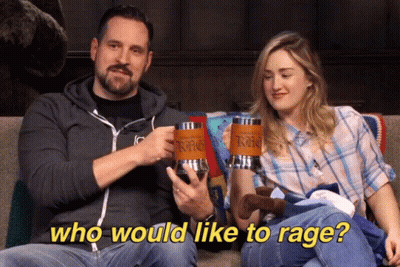 Man And Woman On Couch Holding Mugs Saying Who Would Like To Rage GIF