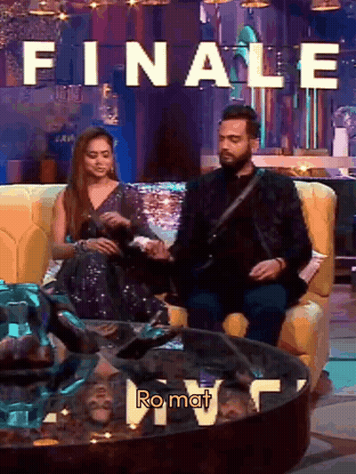Man And Woman On Couch With Finale Ro Mat Sign GIF