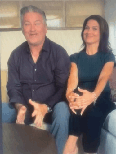 Man And Woman On Couch With Hands On Each Other GIF