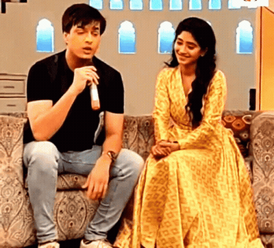 Man And Woman On Couch With Microphone GIF