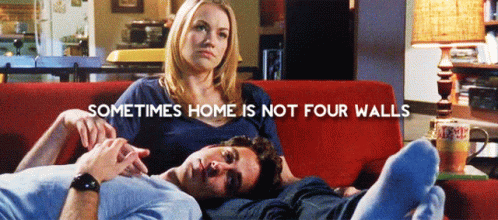 Man And Woman On Red Couch With Sometimes Home Is Not Four Walls GIF