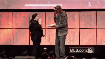 Man And Woman On Stage With MLB.com Logo GIF