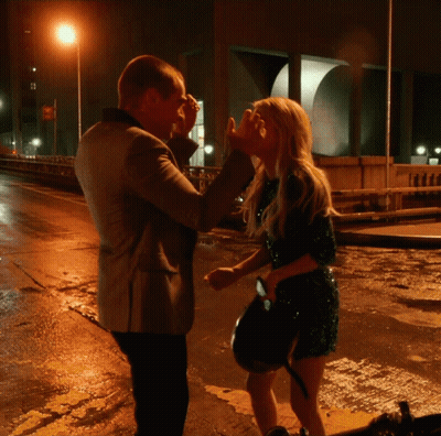 Man And Woman On Wet Street At Night GIF