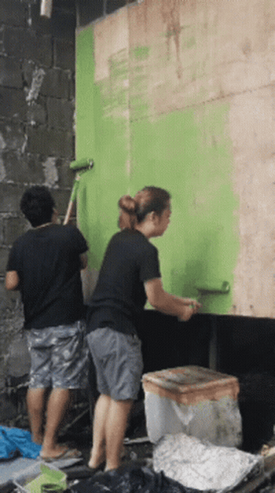Man And Woman Painting Green Wall GIF