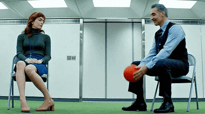 Man And Woman Playing Ball In Chairs GIF