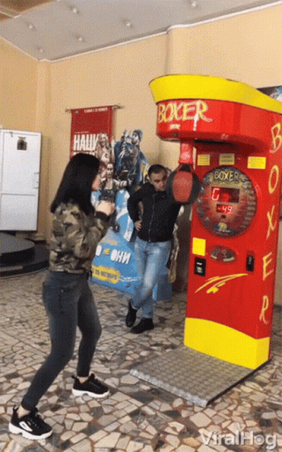 Man And Woman Playing Boxing Machine GIF