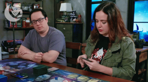 Man And Woman Playing Game At Table GIF