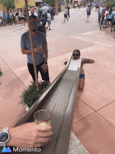 Man And Woman Playing Game With Memento Logo GIF