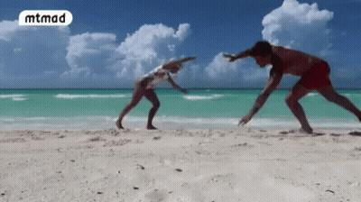 Man And Woman Playing On Beach With Word Mtmad GIF