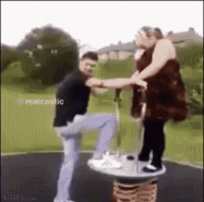 Man And Woman Playing On Merry-Go-Round GIF