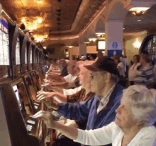 Man And Woman Playing Slot Machine GIF