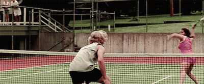Man And Woman Playing Tennis With A & A Sign GIF