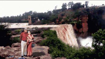 Man And Woman Posing By Waterfall GIF