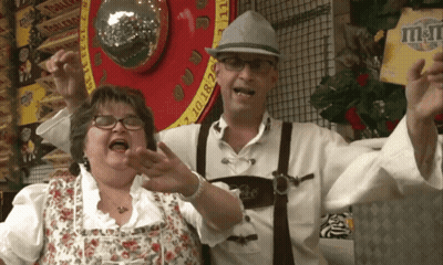 Man and Woman Posing in Front of M&M Sign