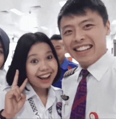 Man And Woman Posing With Chanel Tie GIF