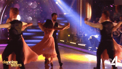 Man And Woman Posing With Disco Ball GIF