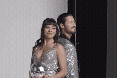 Man And Woman Posing With Disco Ball GIF