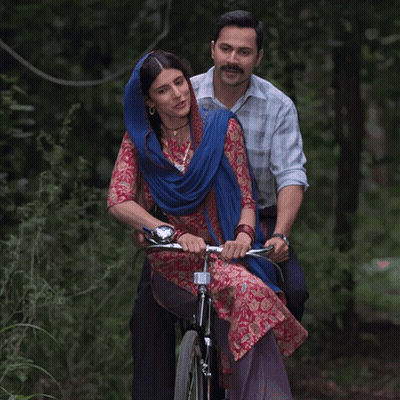 Man And Woman Riding Bicycle In Woods GIF