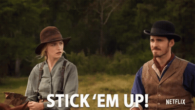 Man And Woman Riding Horses Saying Stick Em Up GIF