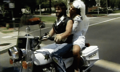 Man And Woman Riding Motorcycle With Police Box GIF