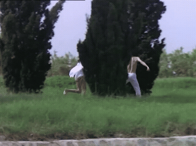 Man And Woman Running In Grassy Field GIF