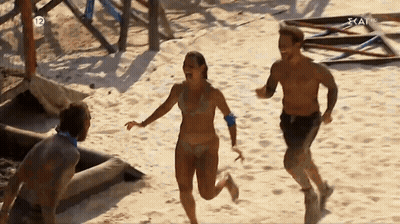 Man And Woman Running On Sandy Beach With Number 12 GIF