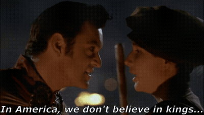 Man And Woman Saying In America We Don't Believe In Kings GIF