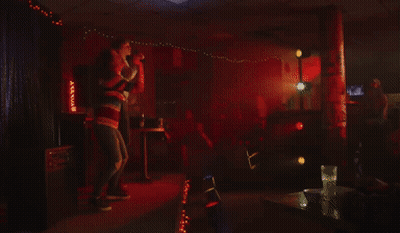 Man And Woman Singing Into Microphones GIF