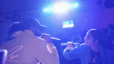 Man And Woman Singing Into Microphones Rise GIF