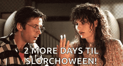 Man And Woman Sitting 2 More Days Til Slorchoween GIF