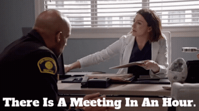 Man and Woman Sitting at Desk There Is a Meeting in an Hour