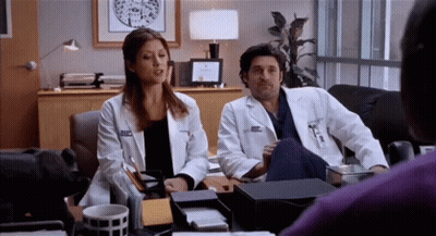 Man And Woman Sitting At Desk Woman With Name Tag Amanda GIF