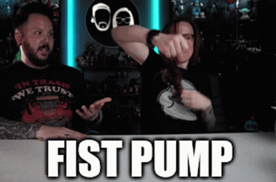 Man And Woman Sitting At Fist Pump Table GIF